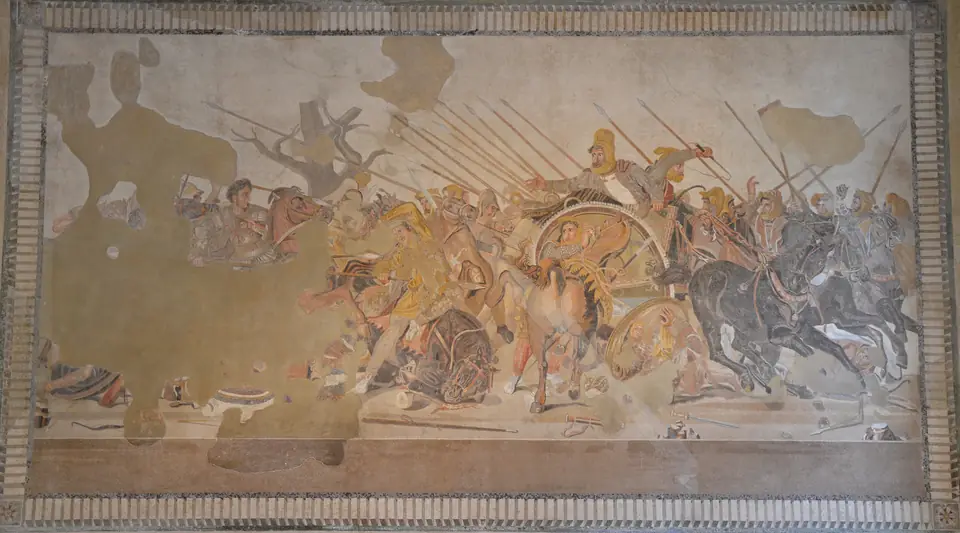 A crowded mosaic battle scene: a bareheaded rider charges from the left toward a ruler in a chariot who turns back in alarm.