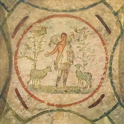 A faded wall painting of a young shepherd carrying a sheep across his shoulders, between animals and trees.