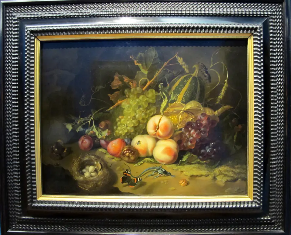 A dark still life of fruit, grain and leaves on a ledge, with insects, a lizard and a bird's nest.