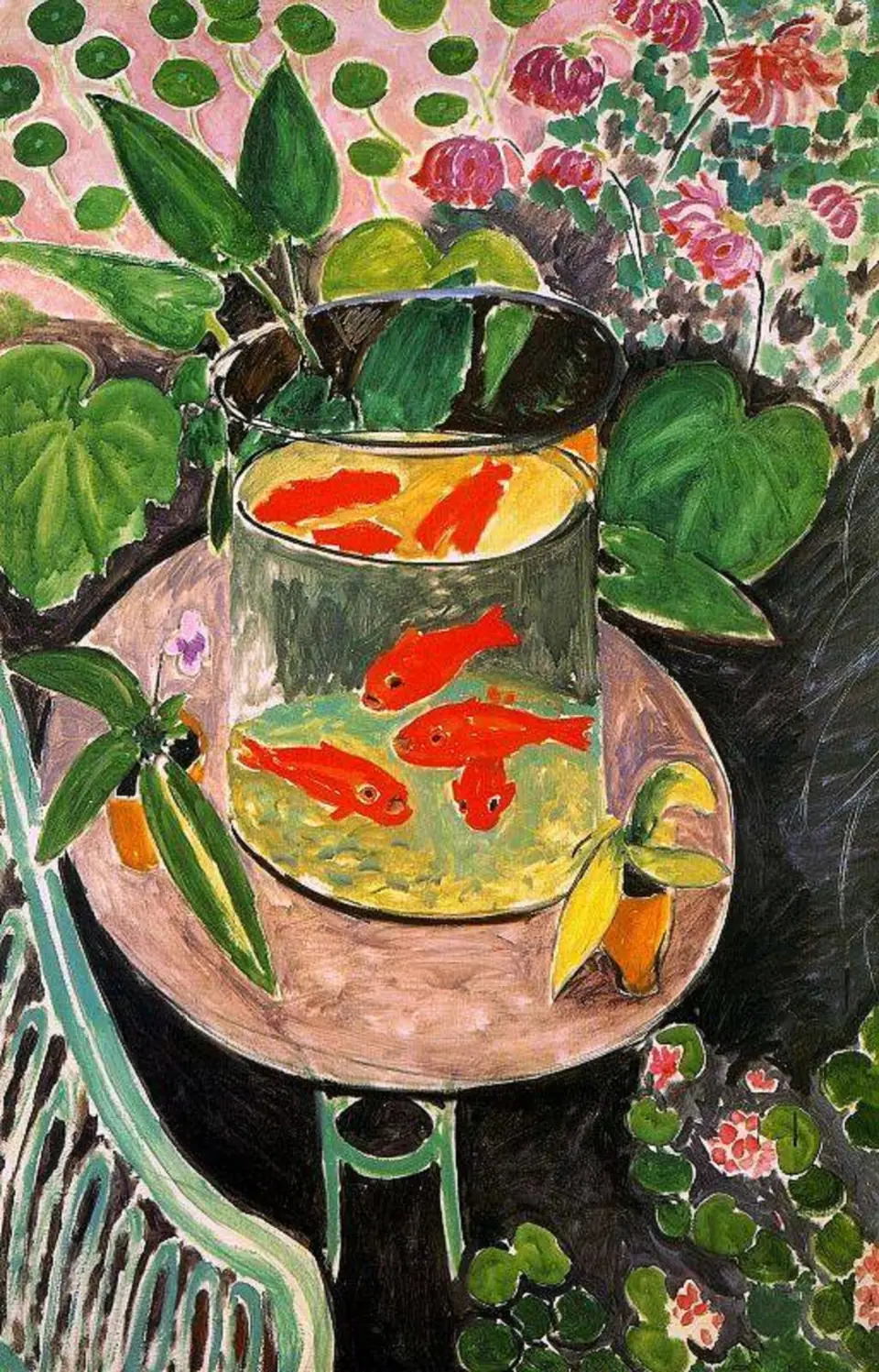 Orange goldfish swimming in a glass bowl on a small round table surrounded by green plants and flowers.