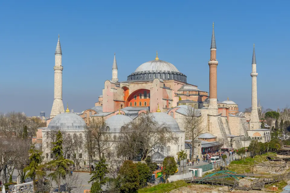 A massive domed building with cascading half domes and four tall, slender towers at its corners.