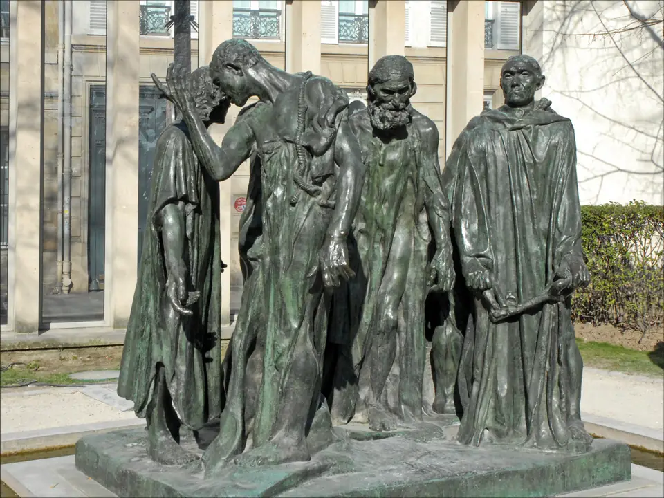 A bronze group of six men in rough robes with ropes around their necks, walking with gestures of despair.