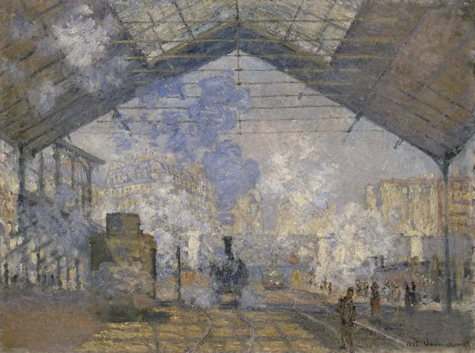 A steam locomotive in a station under a glass and iron roof, filled with clouds of blue and white steam.