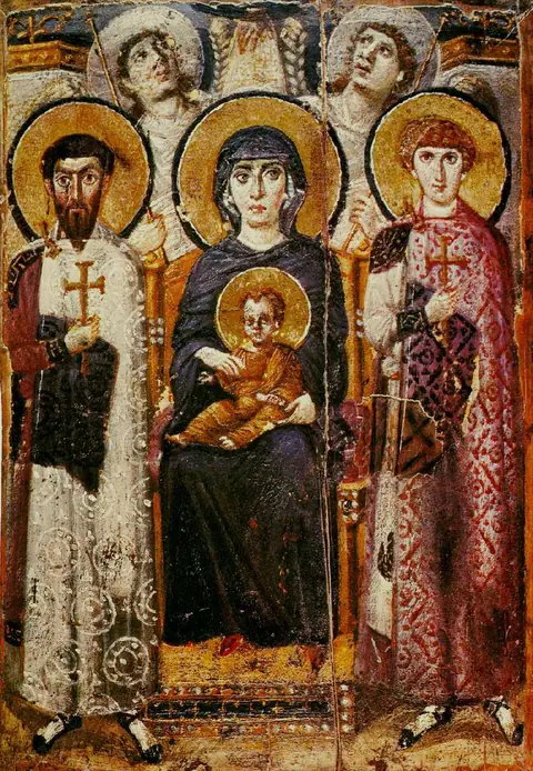 A painted wooden panel of an enthroned woman holding a child between two standing soldier saints, with two angels behind her looking up.